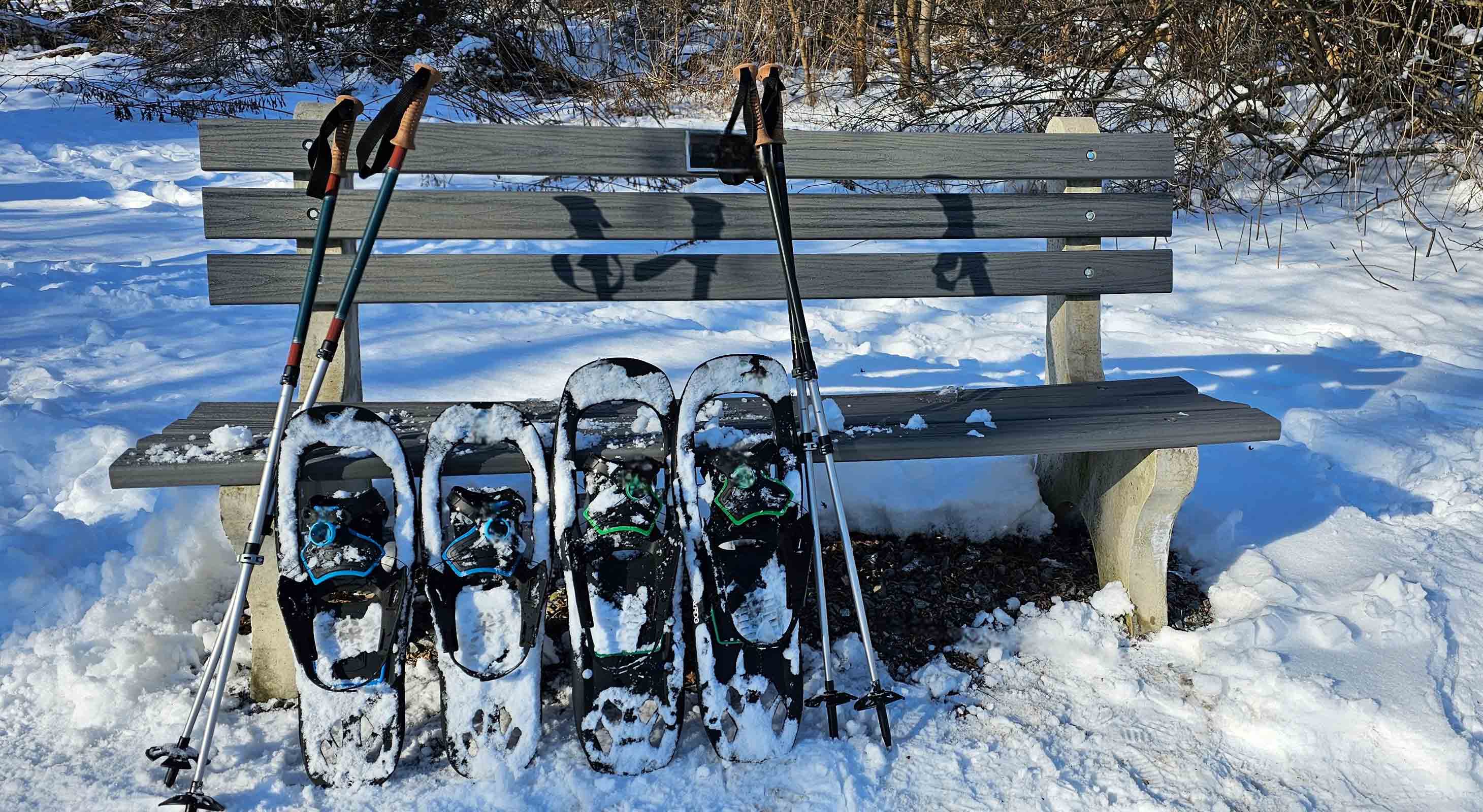 Snowshoeing gear leaning on bench in Vermont snow