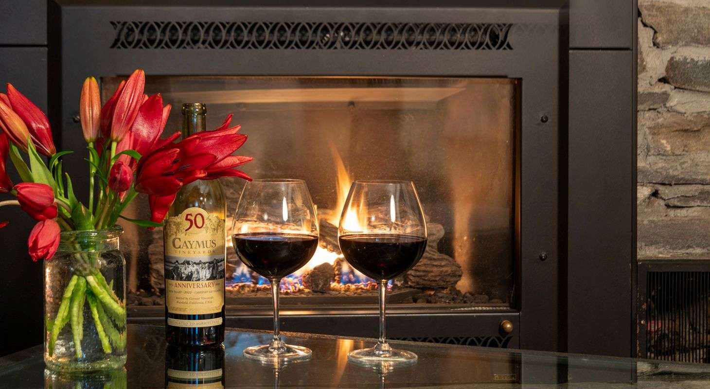 Wine and flowers in front of the fireplace in a honeymoon suit at a lodge in Vermont
