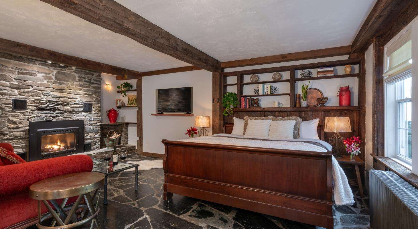 Bed and Fireplace in Premium Honeymoon Room at Tucker Hill Lodge