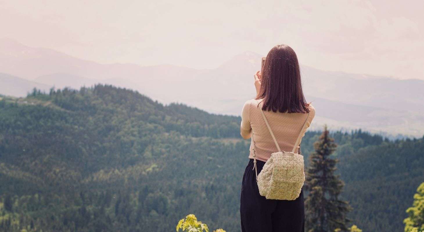 Woman taking a photo of the mountains in the Mad River Valley