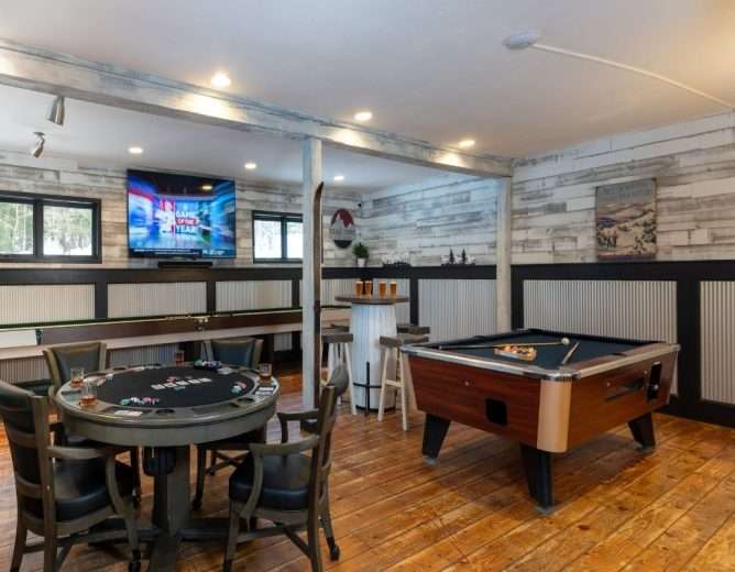 A poker table and pool table in the game room at White Horse Lodge in Vermont