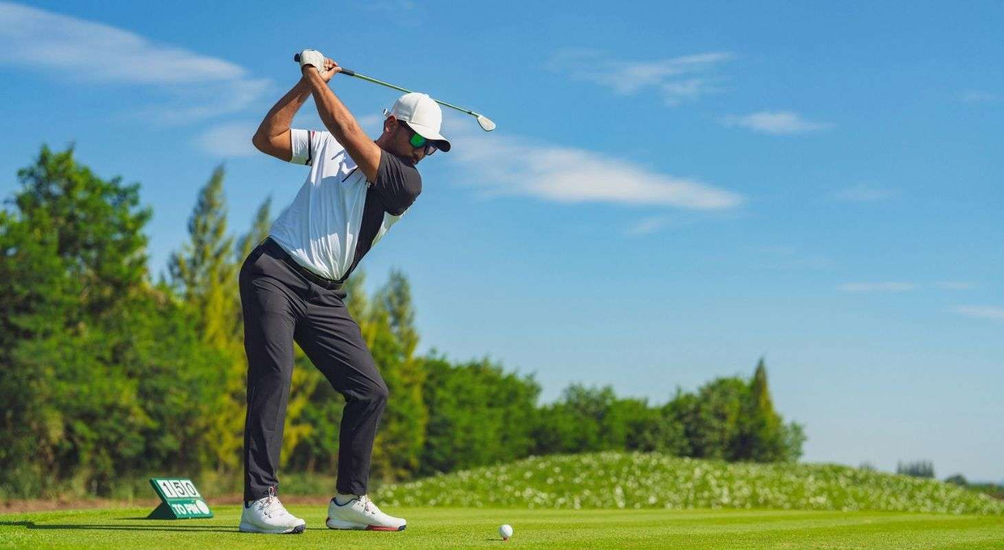 A man teeing off at the Sugarbush Golf Course in Warren, VT