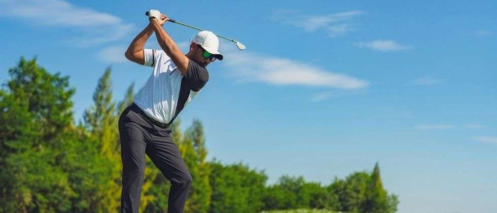 A man teeing off at the Sugarbush Golf Course in Warren, VT