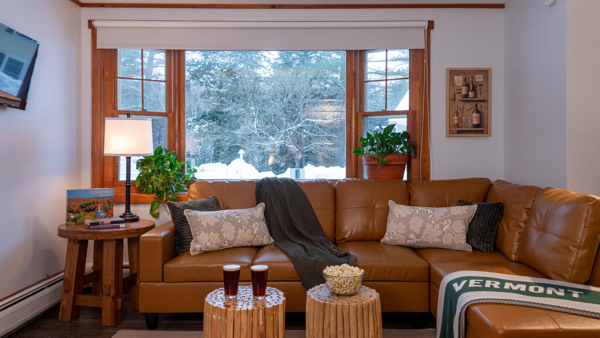 A leather sectional couch in the seating area of a honeymoon suite at our Vermont Mountain Retreat