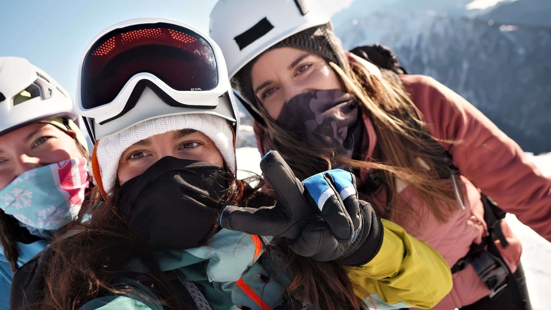 A group of women in ski gear taking a selfie on a mountain during a Vermont winter girls' getaway.