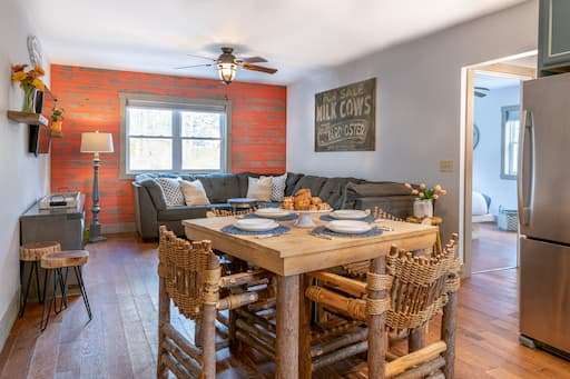 A dining table and large sectional sofa in the living area of our Vermont lodging