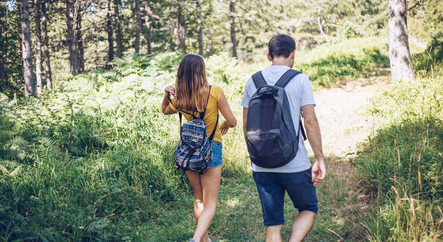 A couple in Vermont, hiking on a trail at Sugarbush Resort