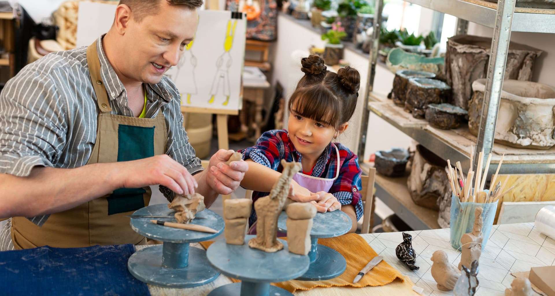 A father and daughter sculpting with clay at a Vermont Art Studio for kids
