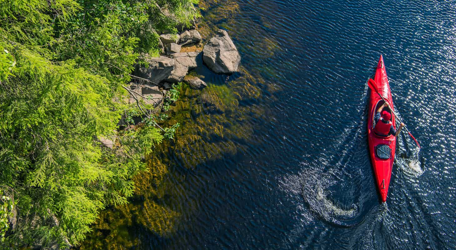A kayaker paddling on the Mad River in Waitsfield, Vermont